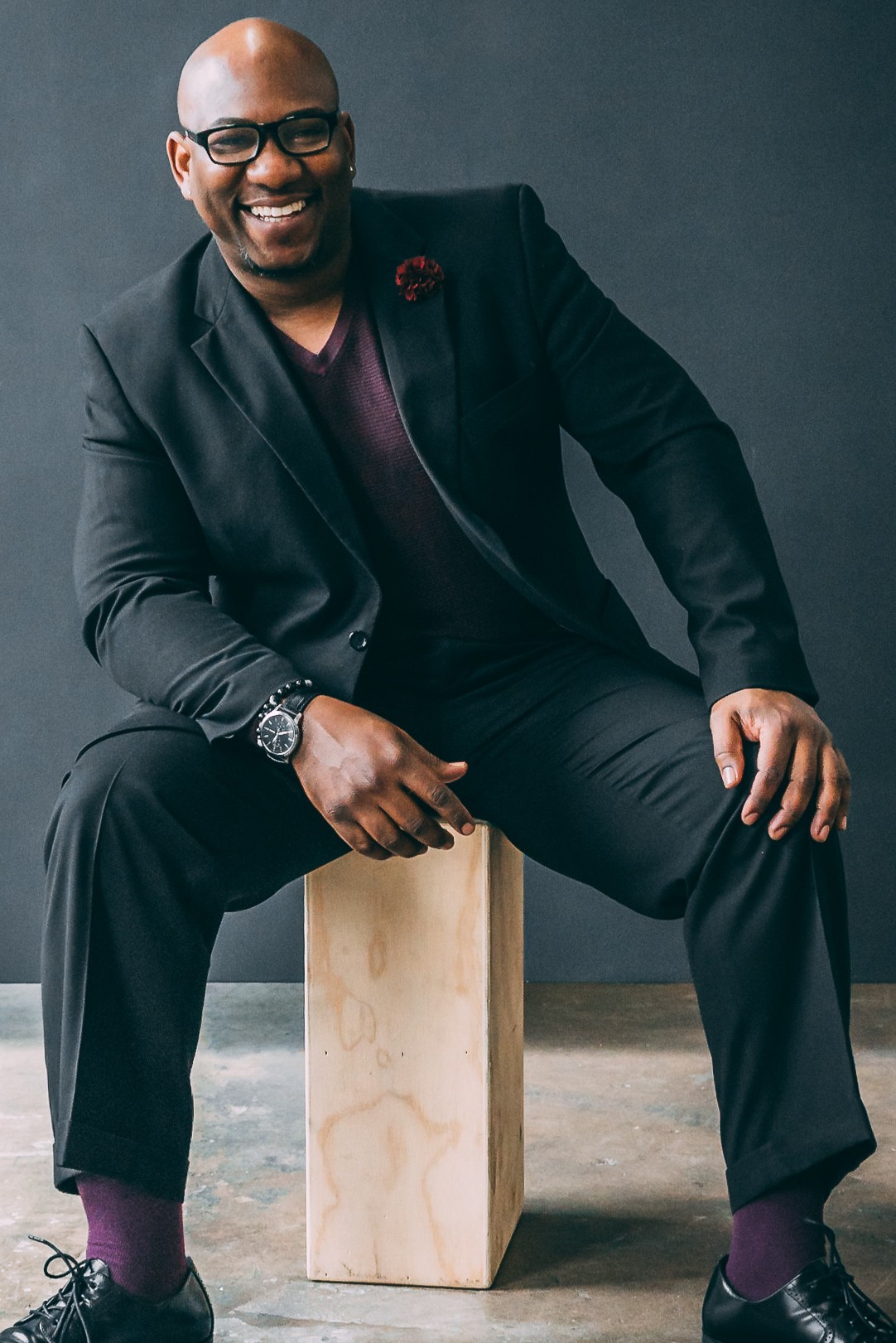 Frankie C. Wilson Jr. smiling, seated in a dark suit
